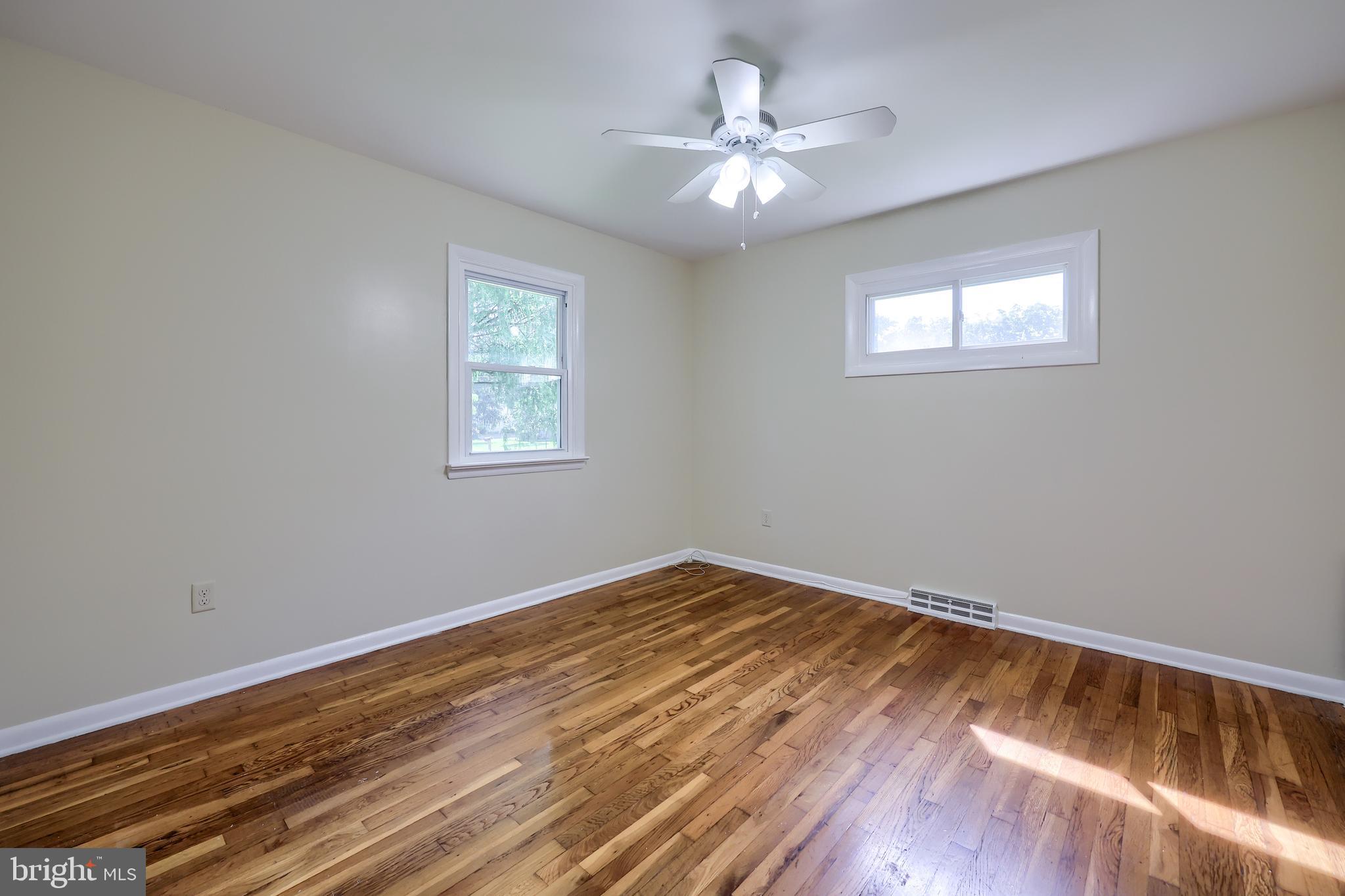 1046 Hunsicker Road Lancaster, PA 17601 - Photo 20 of 31 a view of an empty room with wooden floor and a window