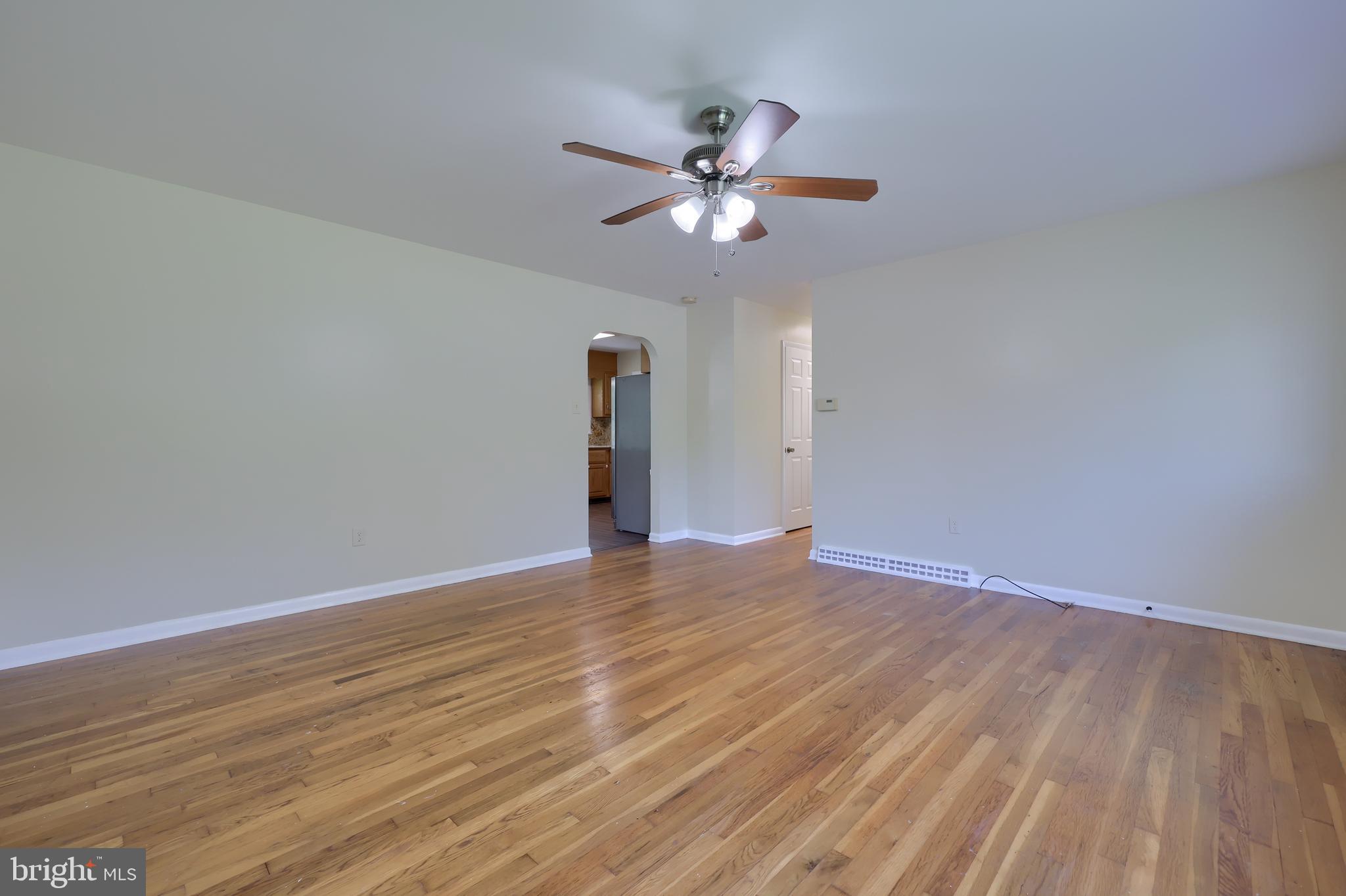 1046 Hunsicker Road Lancaster, PA 17601 - Photo 4 of 31 a view of an empty room with wooden floor and a ceiling fan