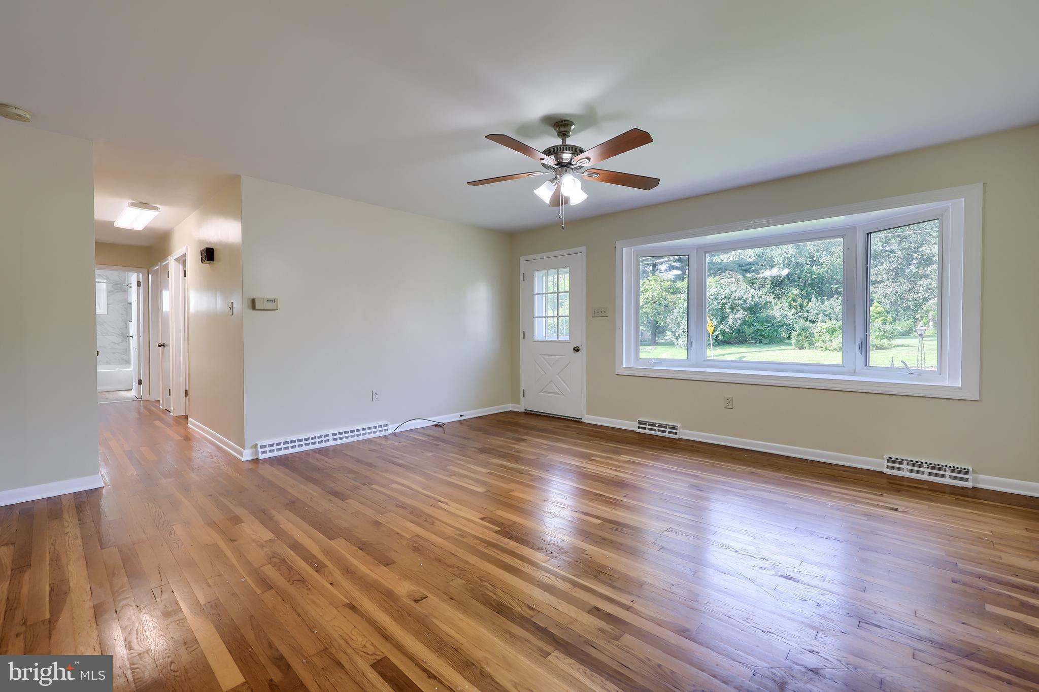 1046 Hunsicker Road Lancaster, PA 17601 - Photo 5 of 31 a view of empty room with wooden floor and fan