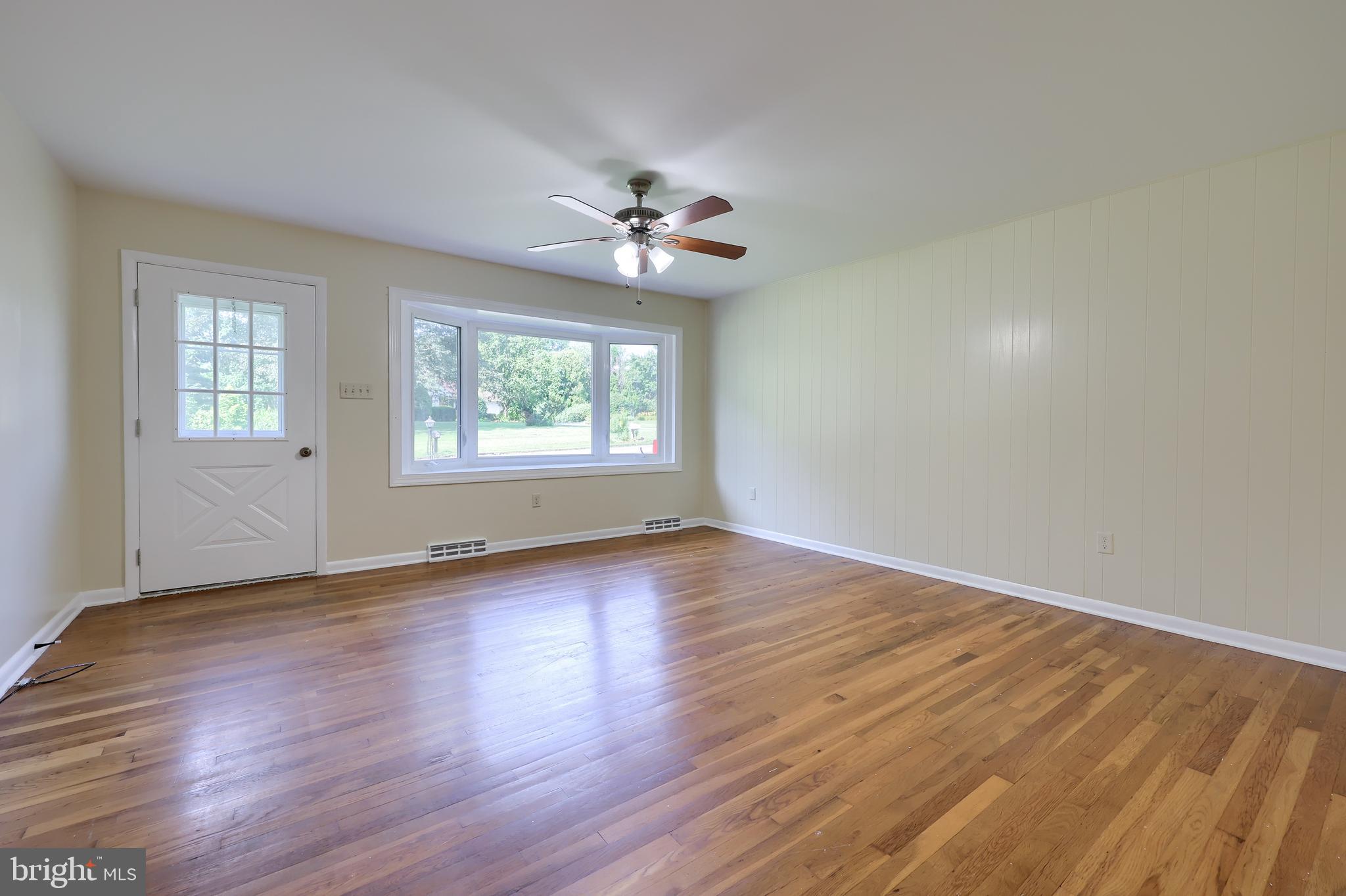 1046 Hunsicker Road Lancaster, PA 17601 - Photo 6 of 31 an empty room with wooden floor ceiling fan and windows