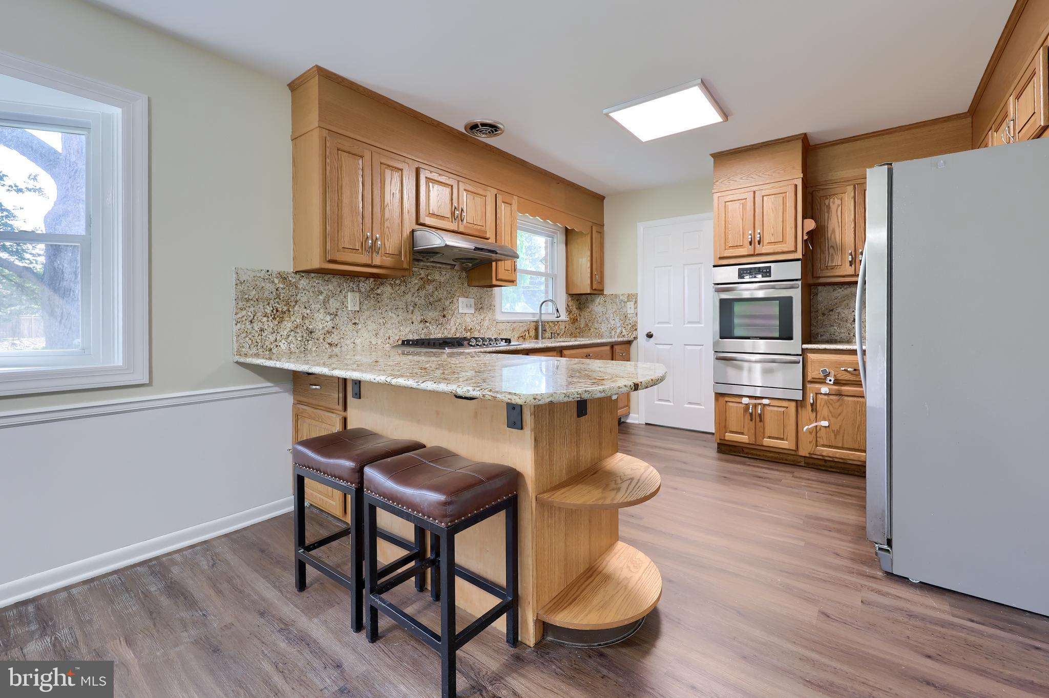 1046 Hunsicker Road Lancaster, PA 17601 - Photo 7 of 31 a kitchen with kitchen island a dining table chairs and refrigerator