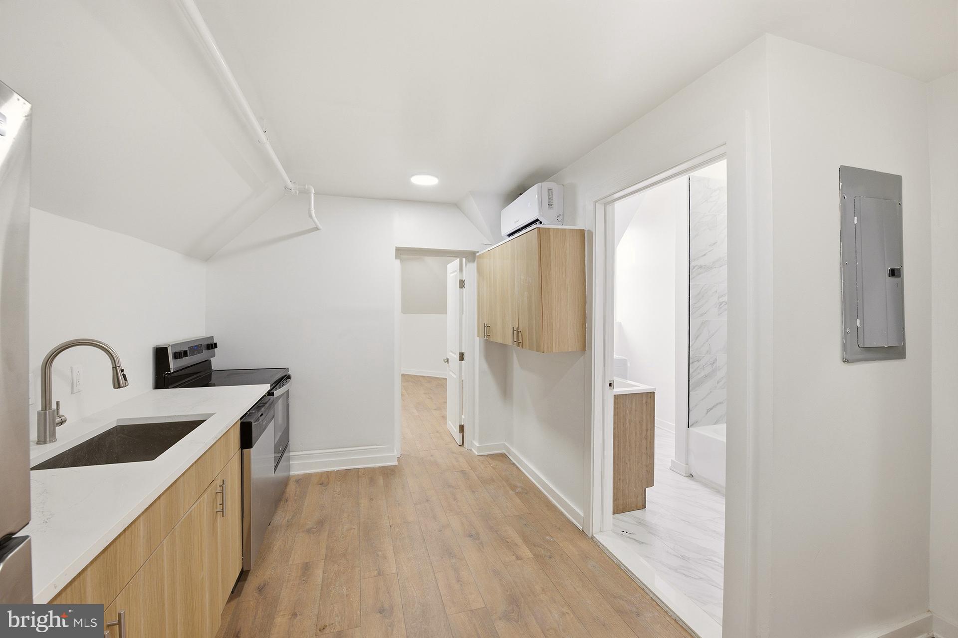 6012 Ridge Avenue, Unit 8 Philadelphia, PA 19128 - Photo 4 of 17 a kitchen with a refrigerator and a sink