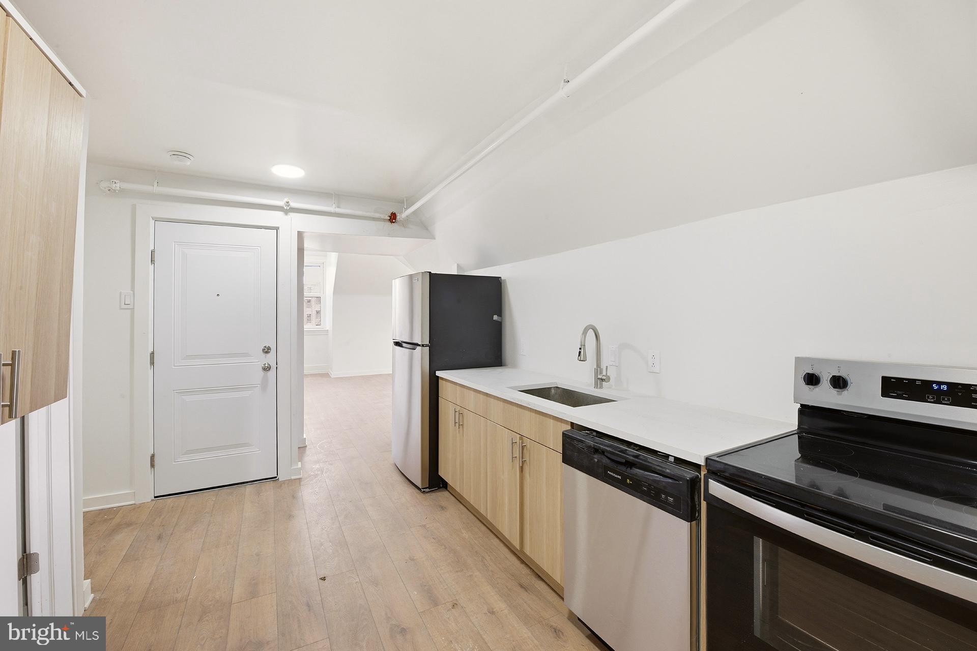 6012 Ridge Avenue, Unit 8 Philadelphia, PA 19128 - Photo 5 of 17 a kitchen with a sink appliances and cabinets