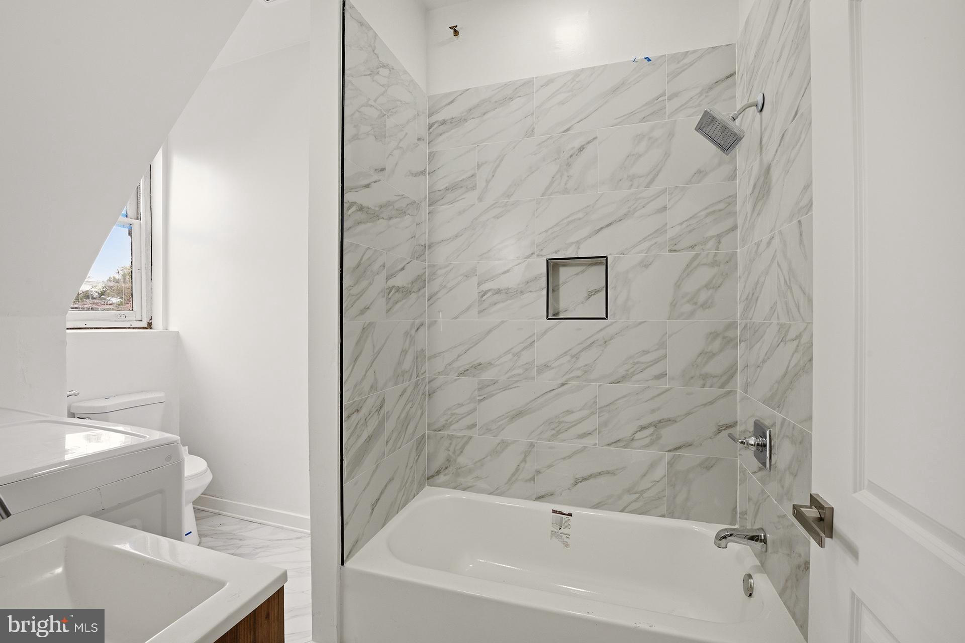 6012 Ridge Avenue, Unit 8 Philadelphia, PA 19128 - Photo 6 of 17 a bathroom with a bathtub and shower