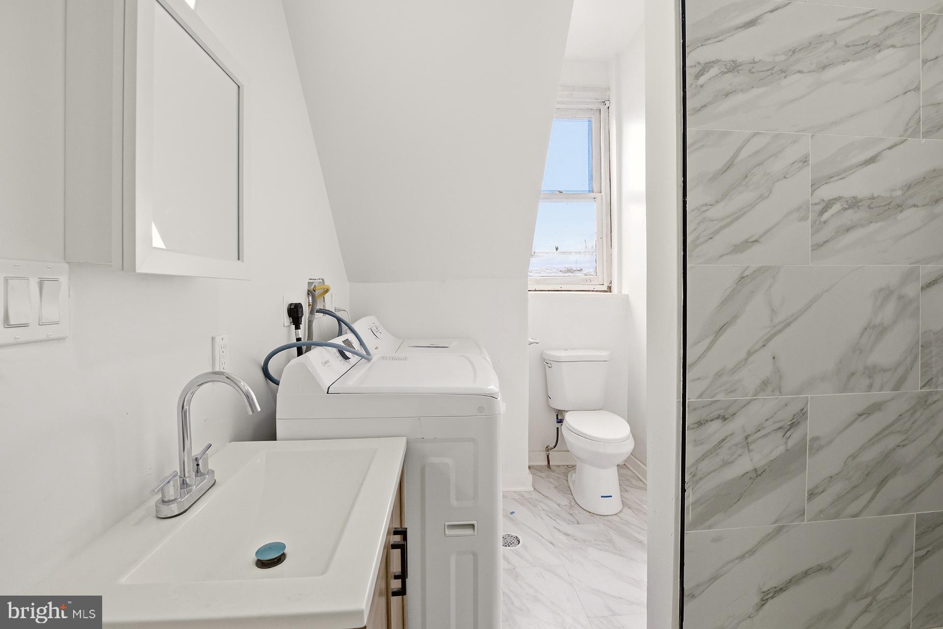 6012 Ridge Avenue, Unit 8 Philadelphia, PA 19128 - Photo 7 of 17 a bathroom with a sink a toilet and shower
