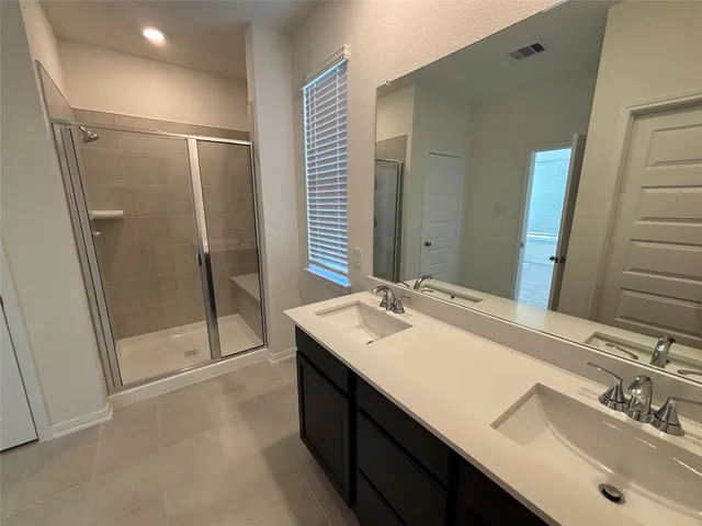 a bathroom with a sink double vanity and shower