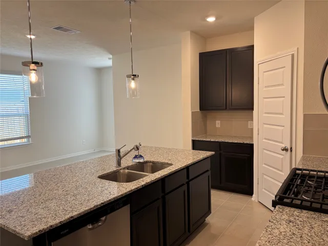 a kitchen with a sink and a refrigerator