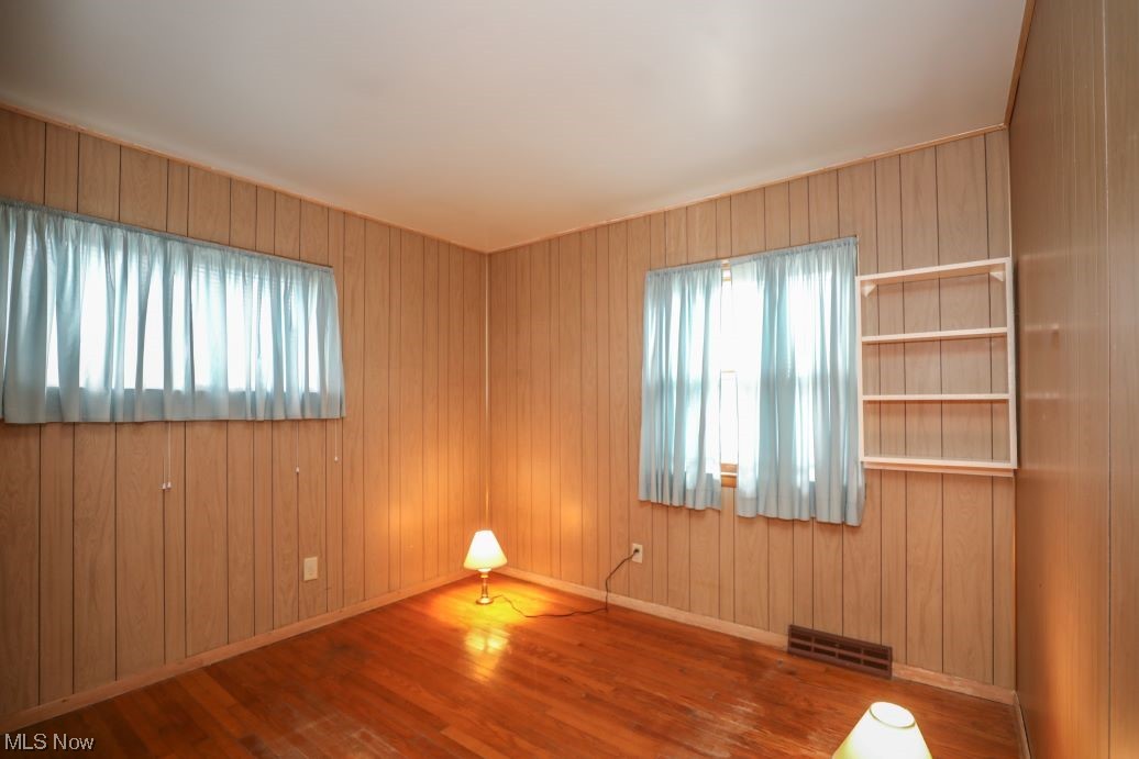 3641 Longfield Road Ravenna, OH 44266 - Photo 25 of 32 Spare room with wooden walls and wood-type flooring