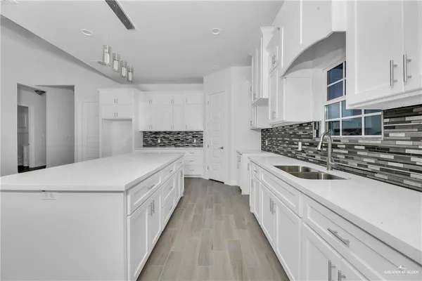a kitchen with stainless steel appliances a sink and cabinets