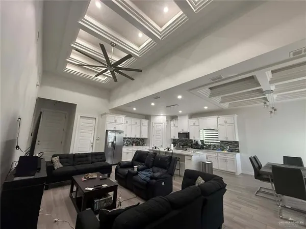 a living room with furniture kitchen view and a window