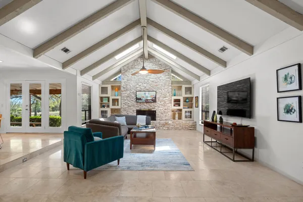 a living room with fireplace furniture and a flat screen tv