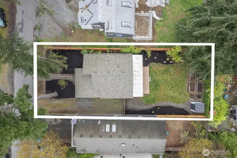 a view of a balcony with a couple of cars parked in front of house