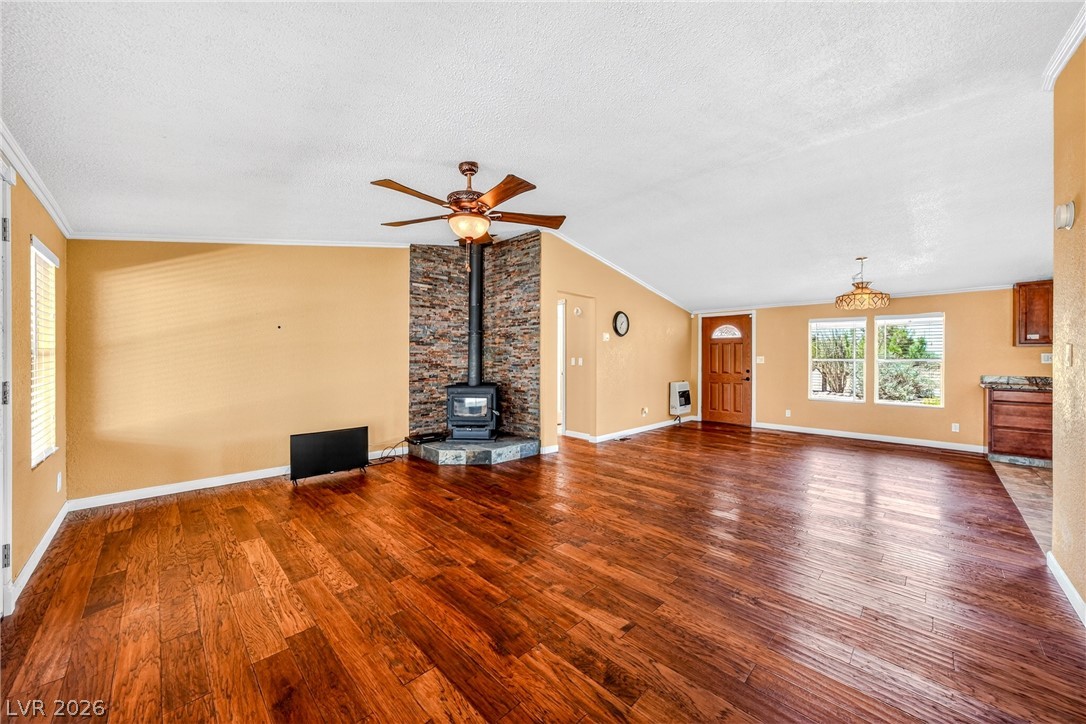 1831 West Horn Road Pahrump, NV 89048 - Photo 9 of 59 Warm wood flooring extends throughout this inviting living space, centered by a charming wood-burning fireplace.