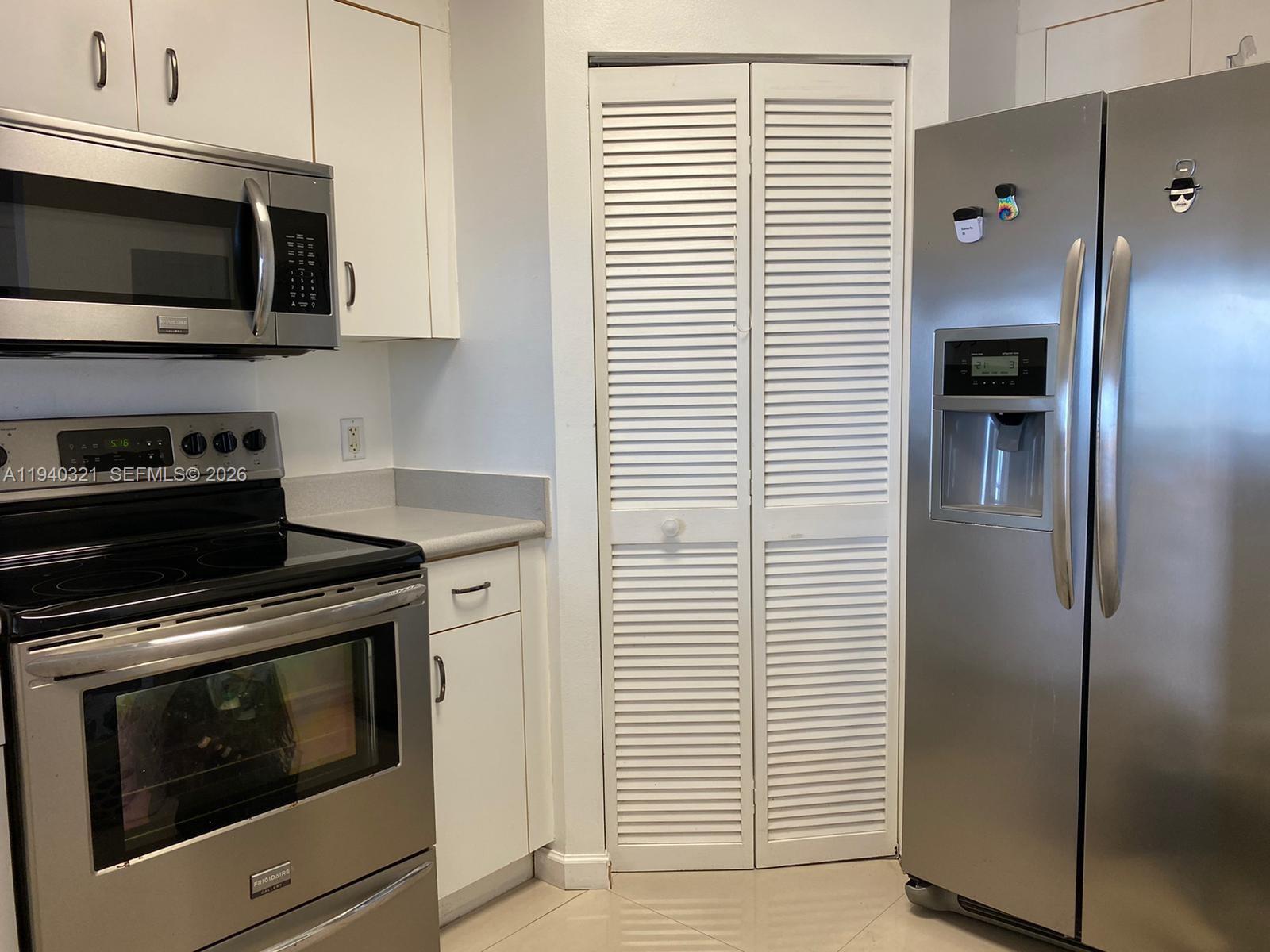 701 Brickell Key Boulevard, Unit LPH01 Miami, FL 33131 - Photo 8 of 15 a kitchen with stainless steel appliances a stove microwave and refrigerator