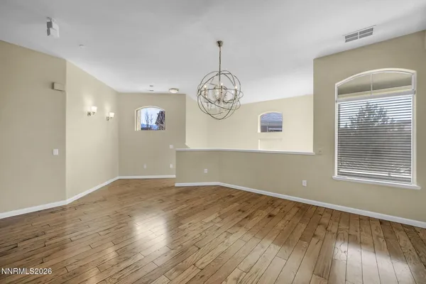 a living room with stainless steel appliances a fireplace and a refrigerator