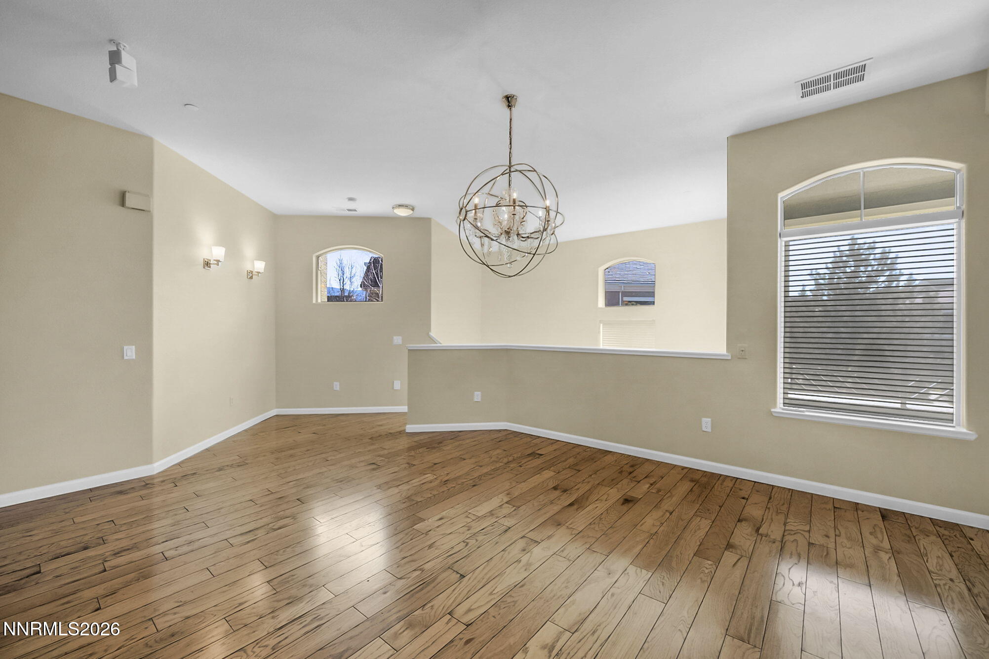 9900 Wilbur May Parkway, Unit 2504 Reno, NV 89521 - Photo 11 of 64 an empty room with wooden floor and windows