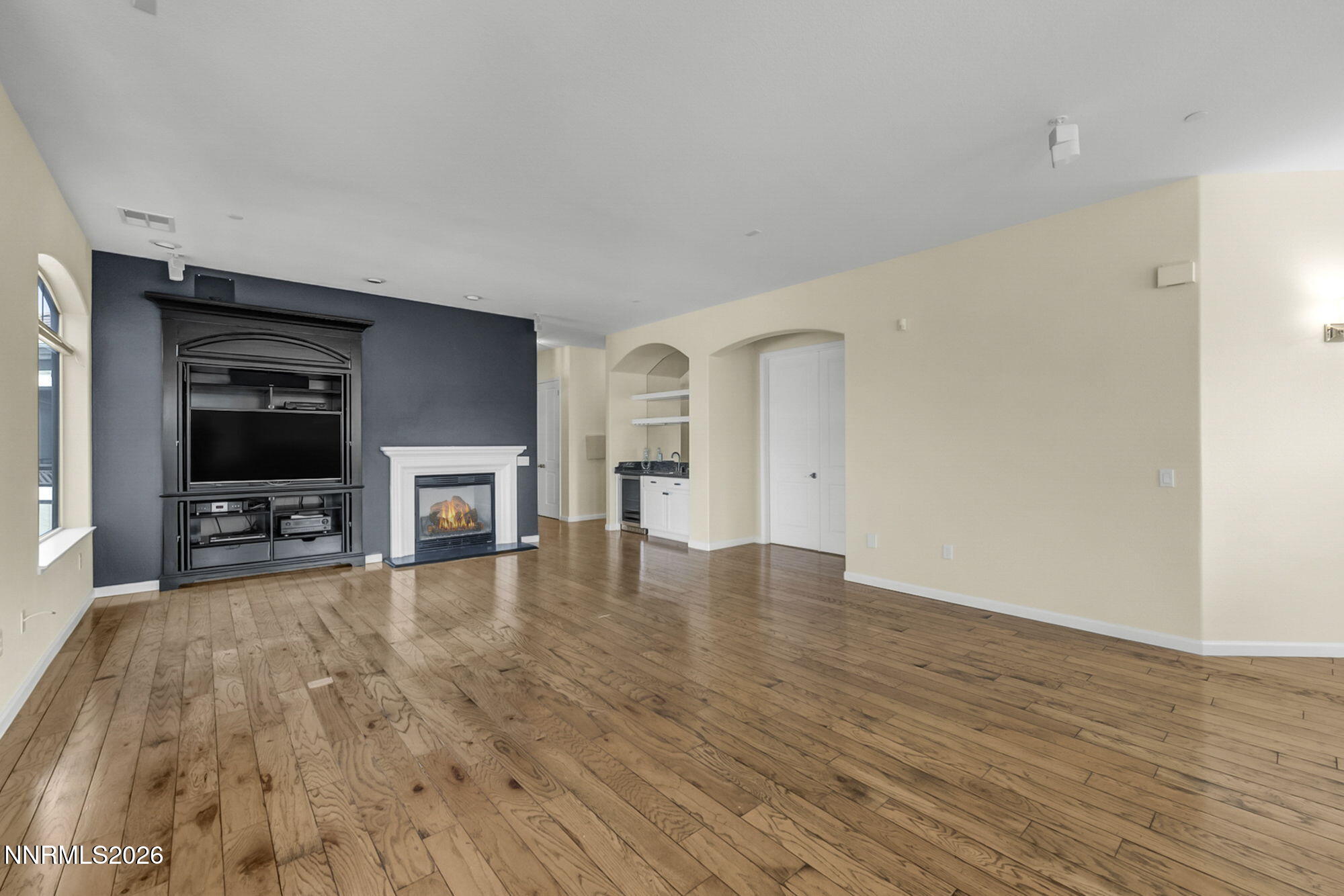 9900 Wilbur May Parkway, Unit 2504 Reno, NV 89521 - Photo 14 of 78 a view of an empty room with wooden floor and a fireplace