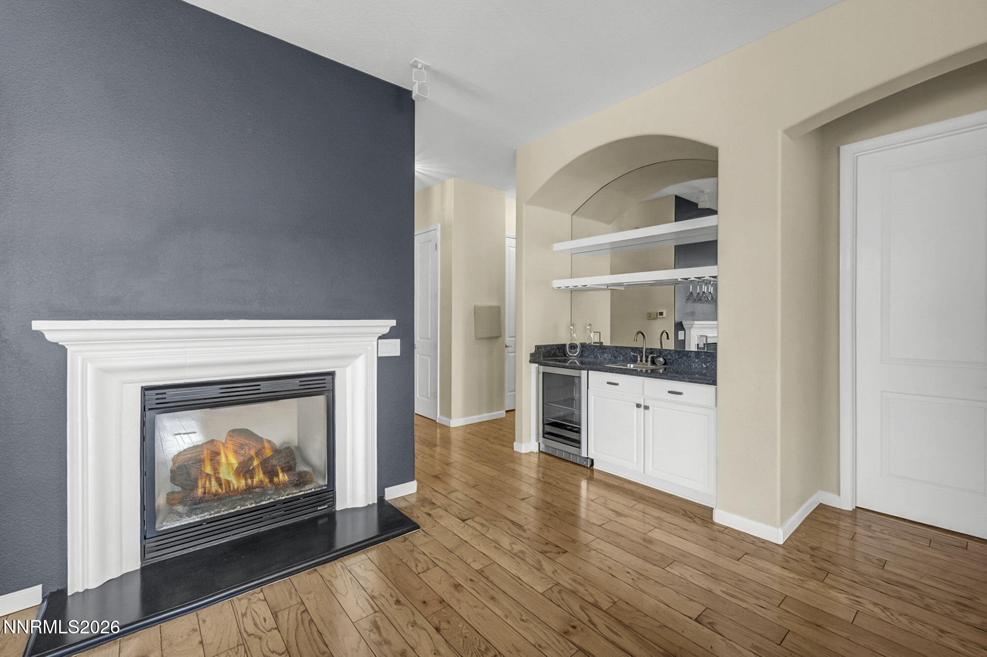 9900 Wilbur May Parkway, Unit 2504 Reno, NV 89521 - Photo 14 of 64 a living room with stainless steel appliances a fireplace and a refrigerator