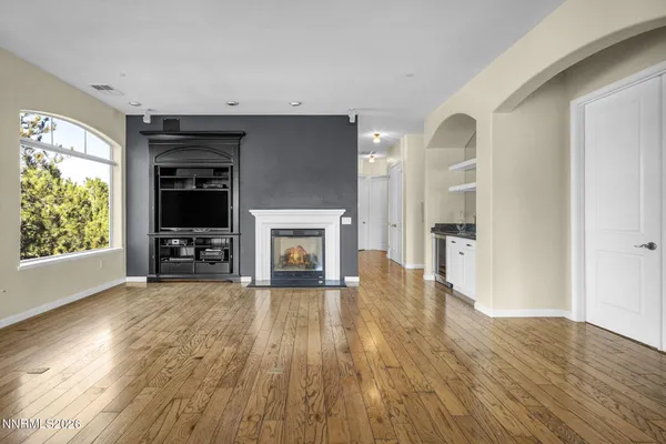 a close view of a stove a sink and dishwasher with wooden floor