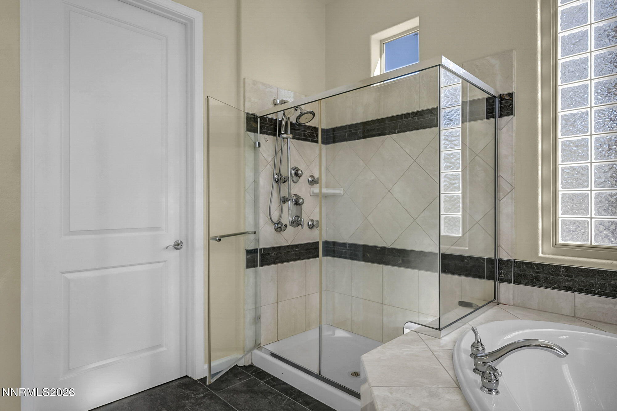 9900 Wilbur May Parkway, Unit 2504 Reno, NV 89521 - Photo 35 of 78 a bathroom with a bathtub and shower