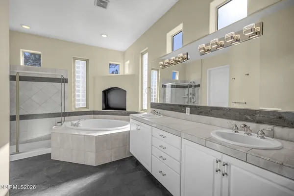 a bathroom with a granite countertop sink a toilet and a mirror
