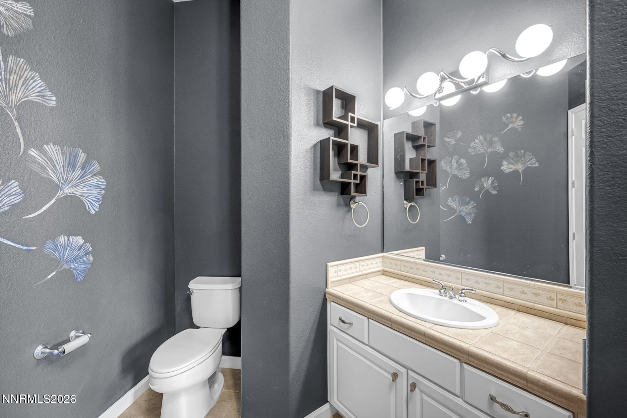 9900 Wilbur May Parkway, Unit 2504 Reno, NV 89521 - Photo 38 of 78 a bathroom with a sink a toilet and a mirror