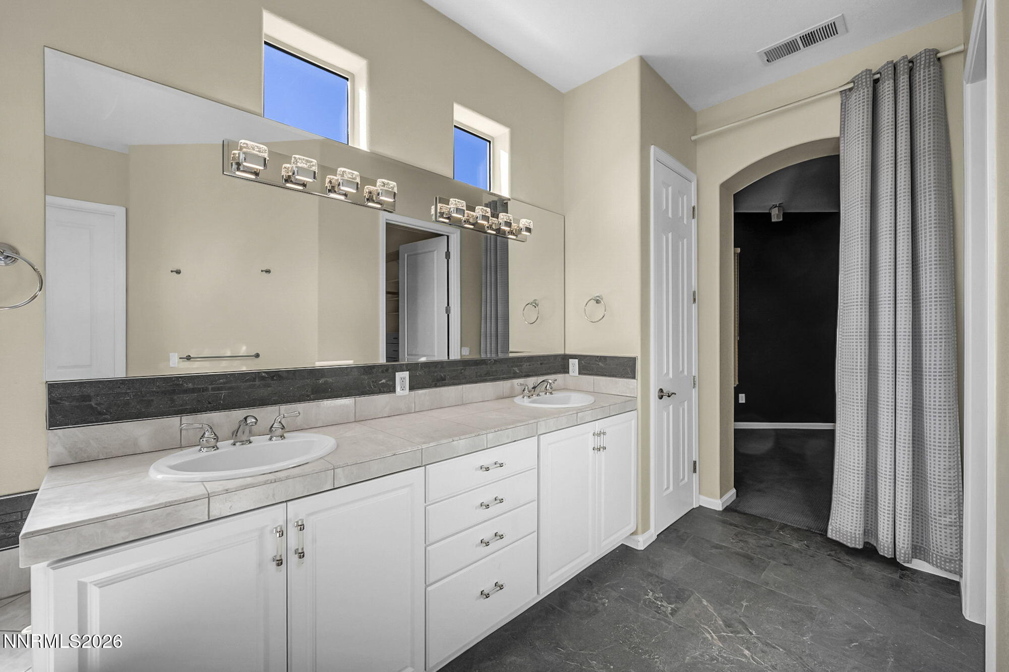 9900 Wilbur May Parkway, Unit 2504 Reno, NV 89521 - Photo 40 of 64 a spacious bathroom with a double vanity sink and a mirror