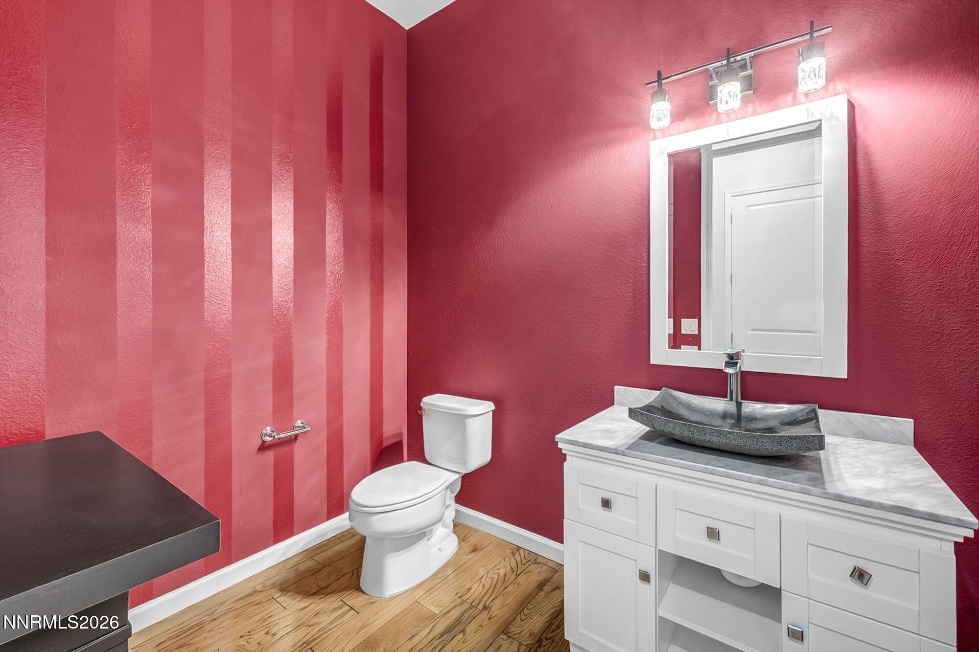 9900 Wilbur May Parkway, Unit 2504 Reno, NV 89521 - Photo 46 of 64 a bathroom with a granite countertop sink a toilet and a mirror