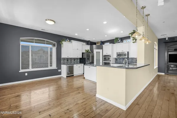 a kitchen with stainless steel appliances granite countertop a refrigerator and a sink