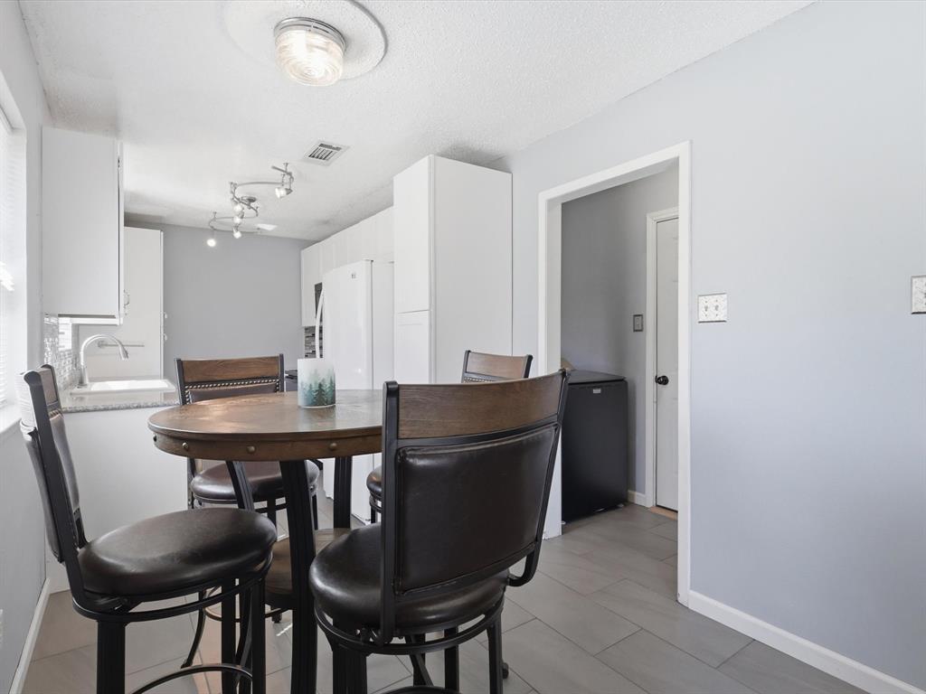 3228 Hummingbird Lane Denton, TX 76209 - Photo 12 of 27 a view of a dining room with furniture