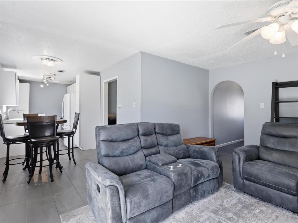 3228 Hummingbird Lane Denton, TX 76209 - Photo 16 of 27 a living room with furniture and a dining table