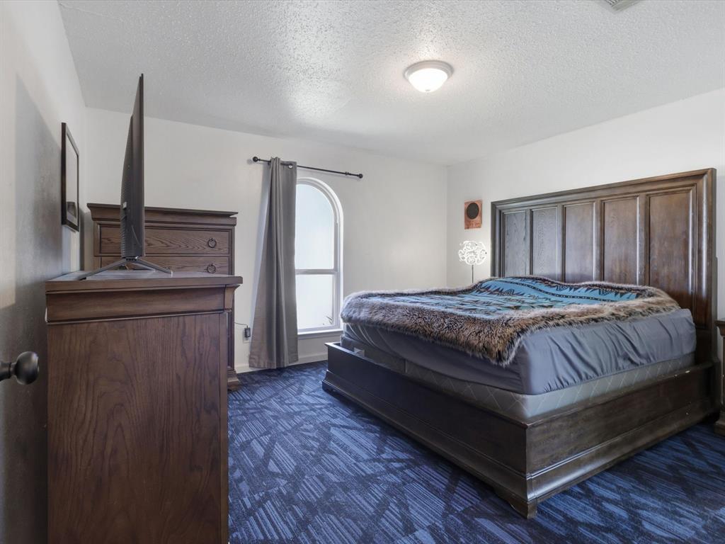 3228 Hummingbird Lane Denton, TX 76209 - Photo 17 of 27 a bedroom with a bed next to a window
