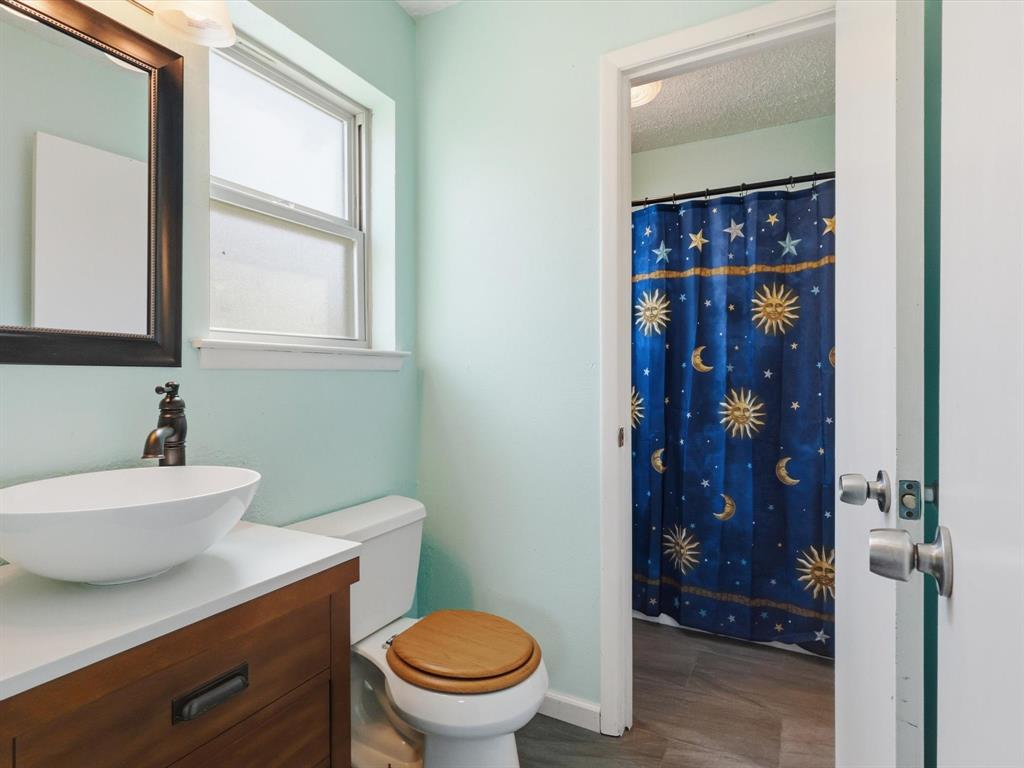 3228 Hummingbird Lane Denton, TX 76209 - Photo 20 of 27 a bathroom with a sink a toilet and shower