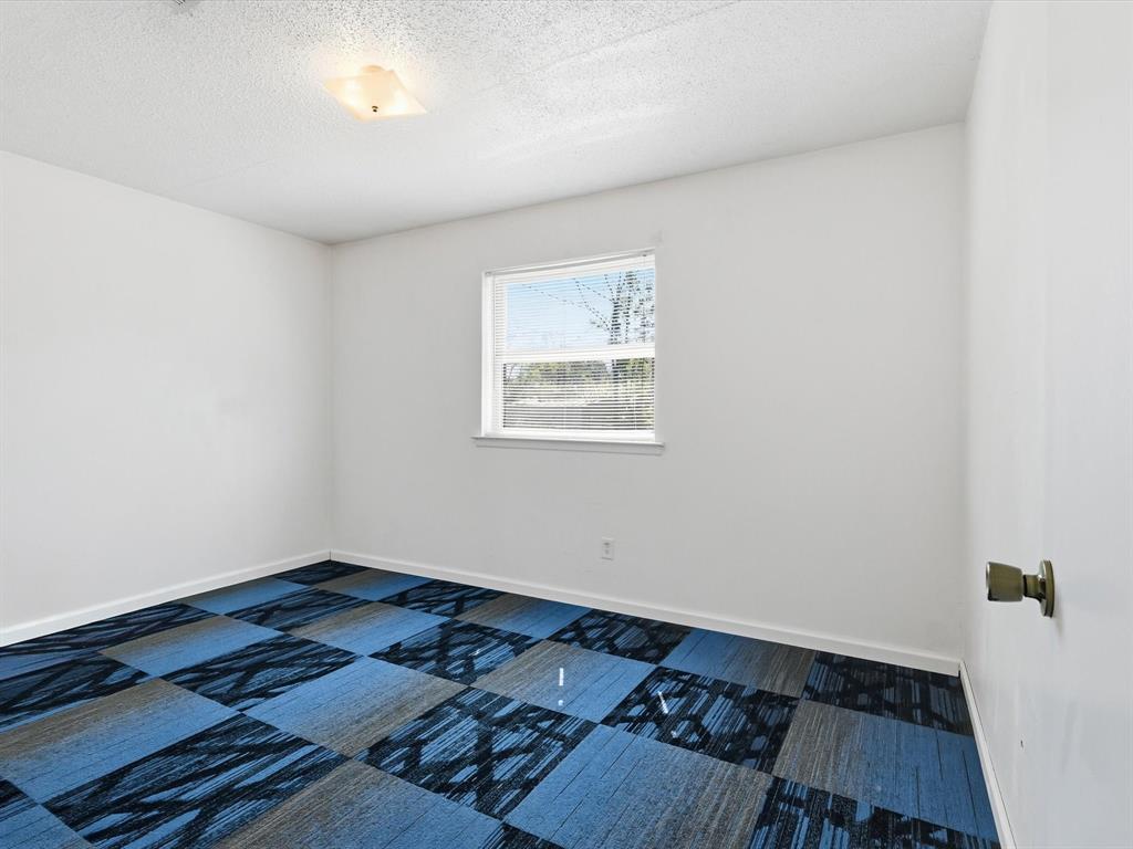 3228 Hummingbird Lane Denton, TX 76209 - Photo 21 of 27 an empty room with wooden floor and windows