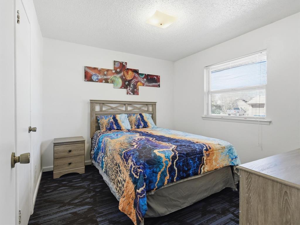 3228 Hummingbird Lane Denton, TX 76209 - Photo 22 of 27 a bedroom with a bed and wall painting on the wall