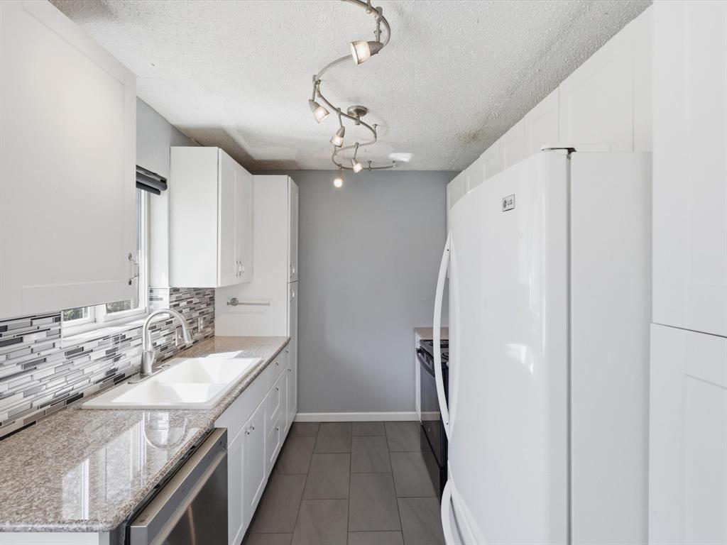 3228 Hummingbird Lane Denton, TX 76209 - Photo 5 of 27 a spacious bathroom with a double vanity sink a mirror and a shower