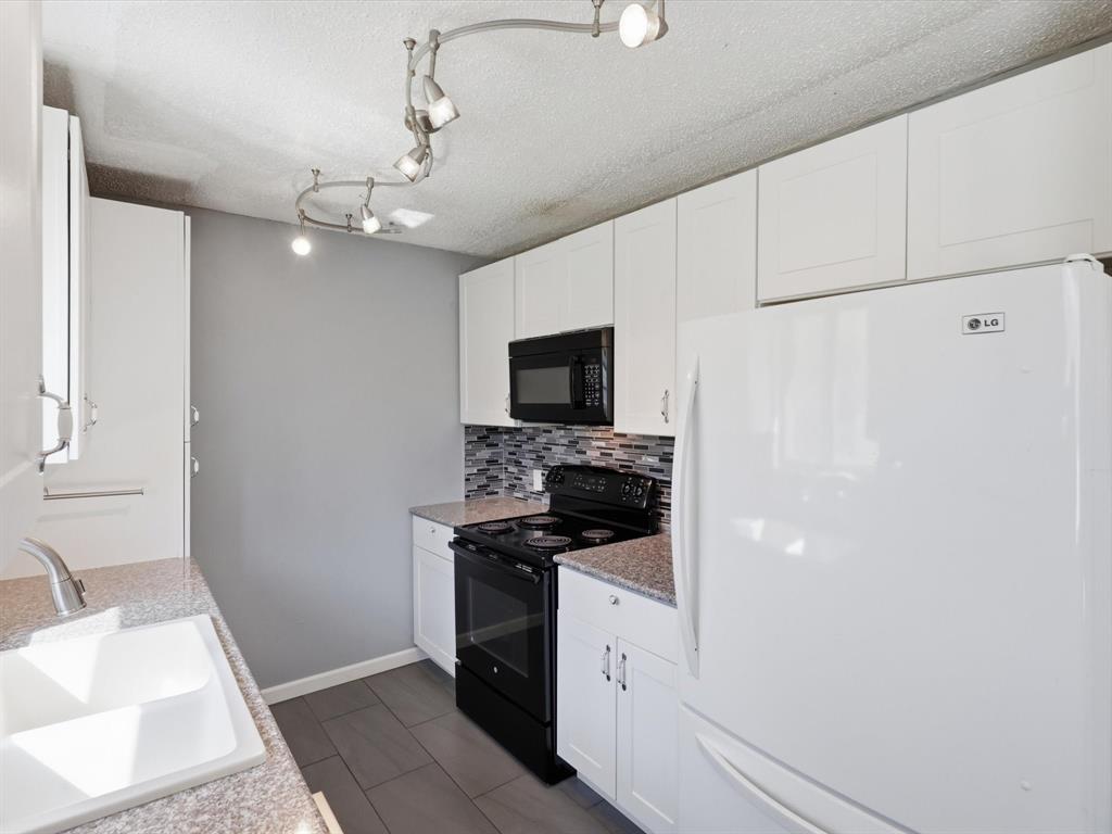 3228 Hummingbird Lane Denton, TX 76209 - Photo 6 of 27 a kitchen with a sink and a stove top oven