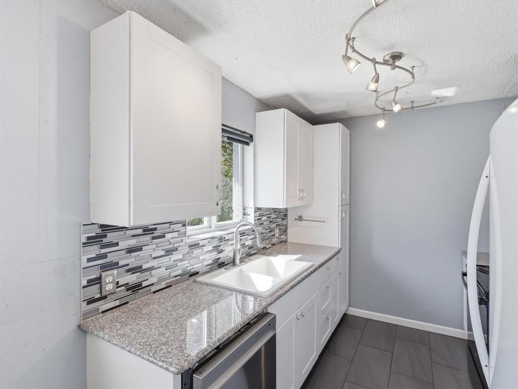 3228 Hummingbird Lane Denton, TX 76209 - Photo 7 of 27 a spacious bathroom with a granite countertop sink and a mirror