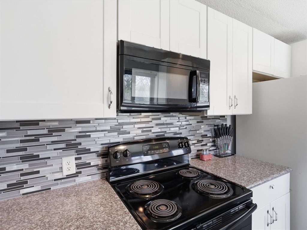 3228 Hummingbird Lane Denton, TX 76209 - Photo 9 of 27 a kitchen with a stove and a microwave
