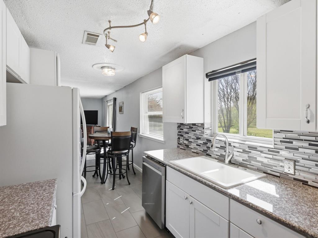 3228 Hummingbird Lane Denton, TX 76209 - Photo 10 of 27 a view of a kitchen area with furniture and window
