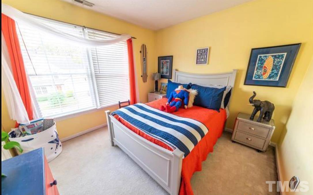 7613 Overland Trail Raleigh, NC 27615 - Photo 12 of 22 a bedroom with bed and a window