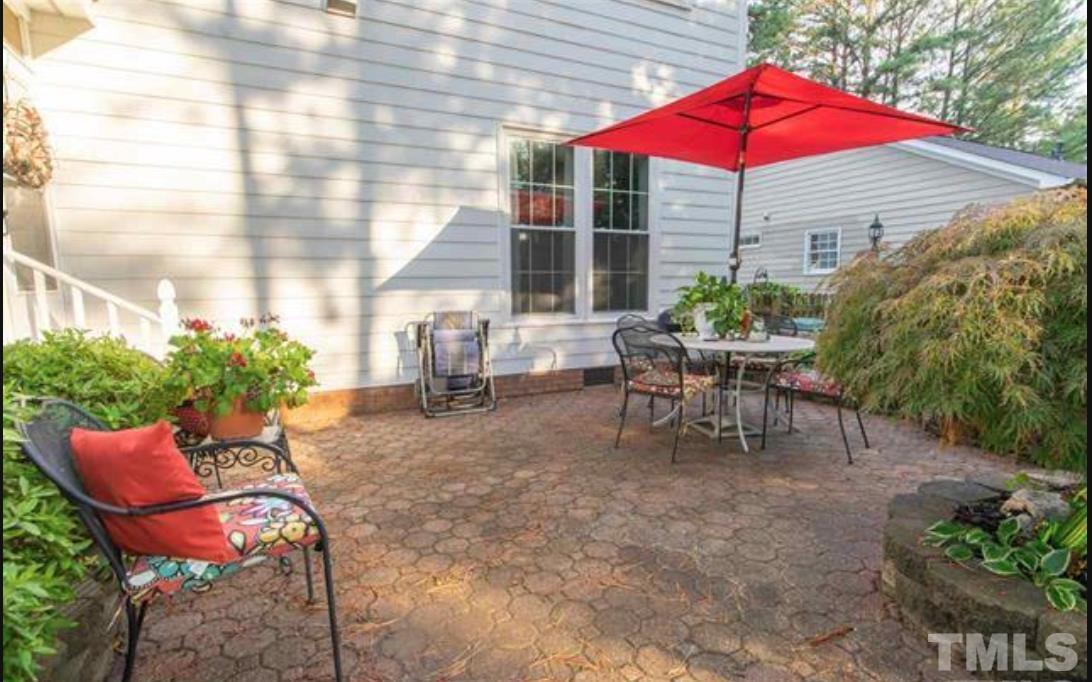 7613 Overland Trail Raleigh, NC 27615 - Photo 18 of 22 a view of a house with backyard sitting area and garden