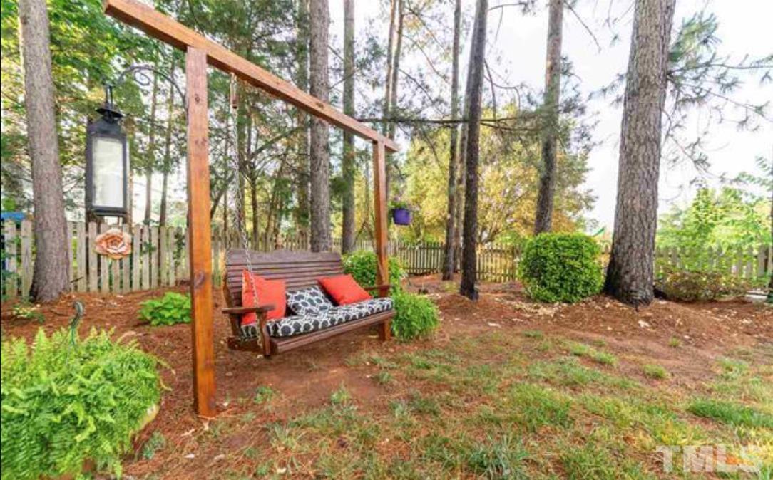 7613 Overland Trail Raleigh, NC 27615 - Photo 19 of 22 a backyard of a house with lots of green space and outdoor seating