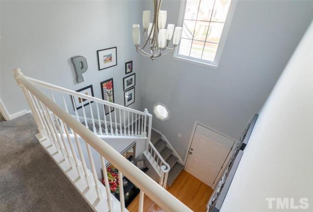 7613 Overland Trail Raleigh, NC 27615 - Photo 7 of 22 a view of staircase with lots of frames on wall and a window