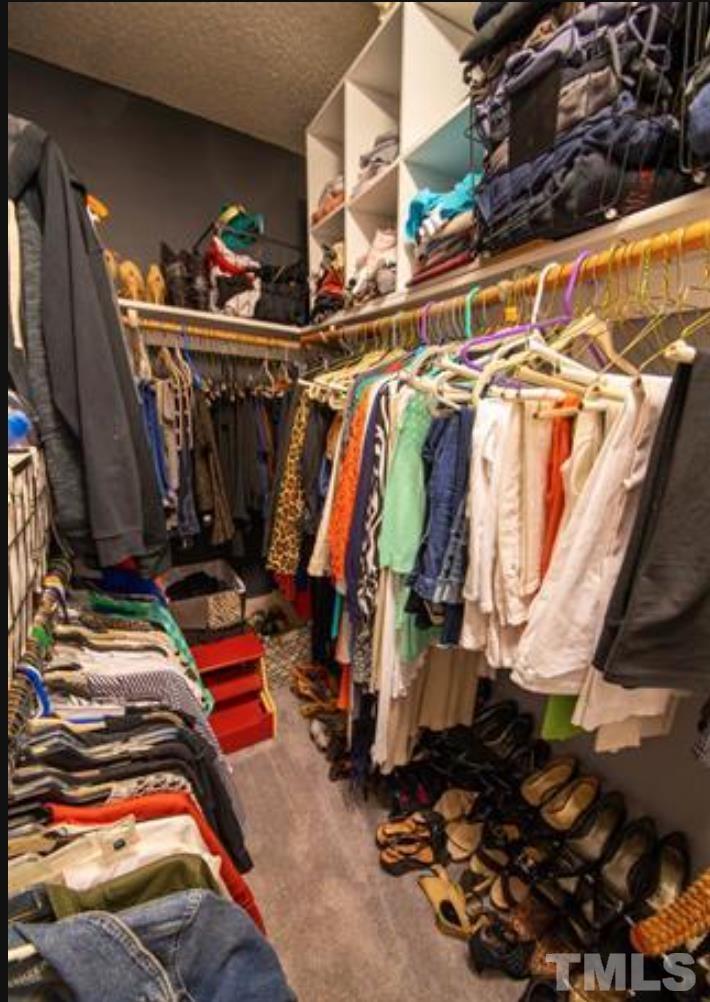 7613 Overland Trail Raleigh, NC 27615 - Photo 10 of 22 a view of walk in closet with clothes and shoes