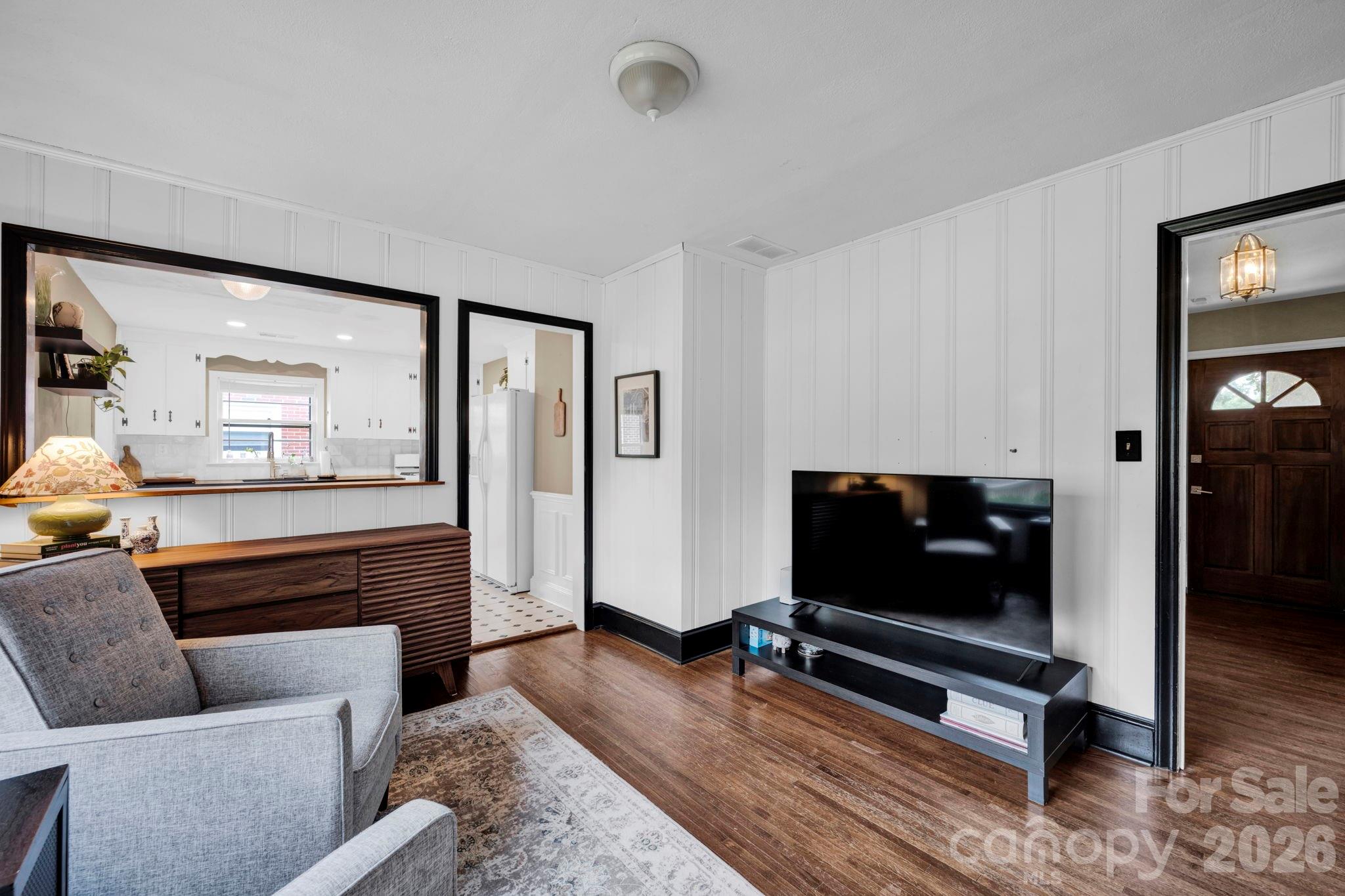 1227 Barkley Road Charlotte, NC 28209 - Photo 12 of 37 a living room with furniture and a flat screen tv