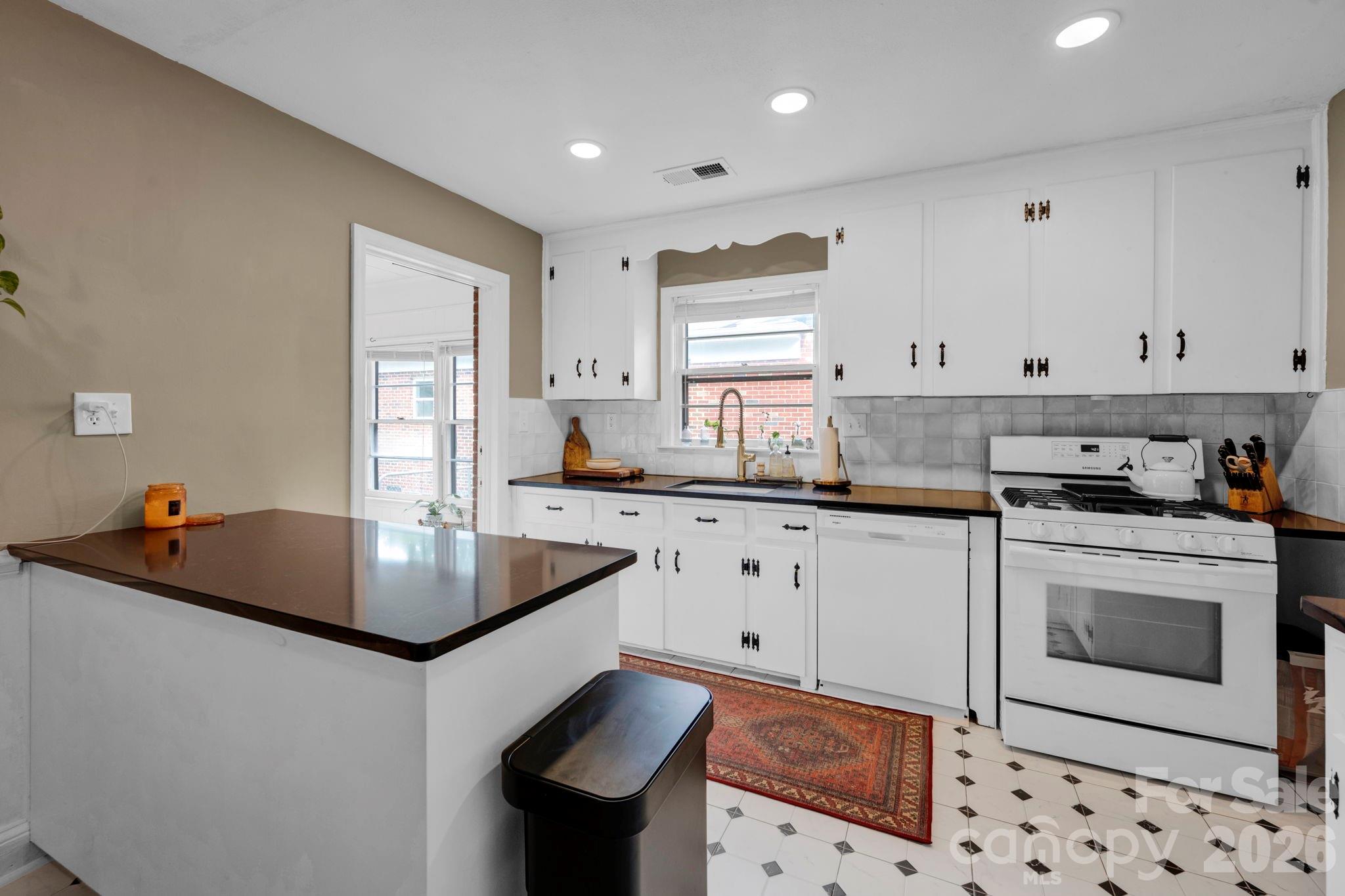 1227 Barkley Road Charlotte, NC 28209 - Photo 13 of 37 a kitchen with granite countertop a sink stove and cabinets