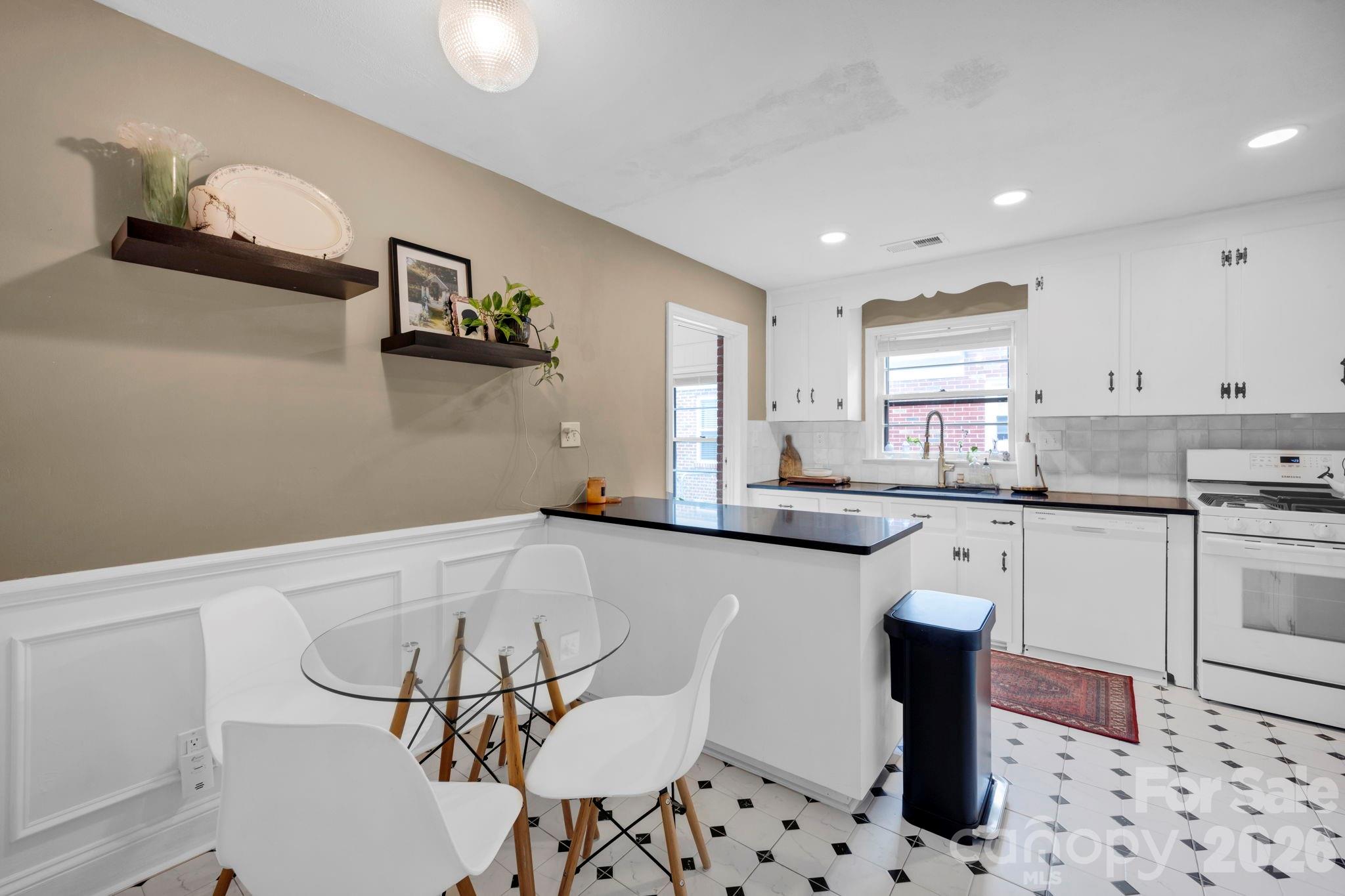 1227 Barkley Road Charlotte, NC 28209 - Photo 16 of 37 a kitchen with granite countertop a white cabinets and appliances