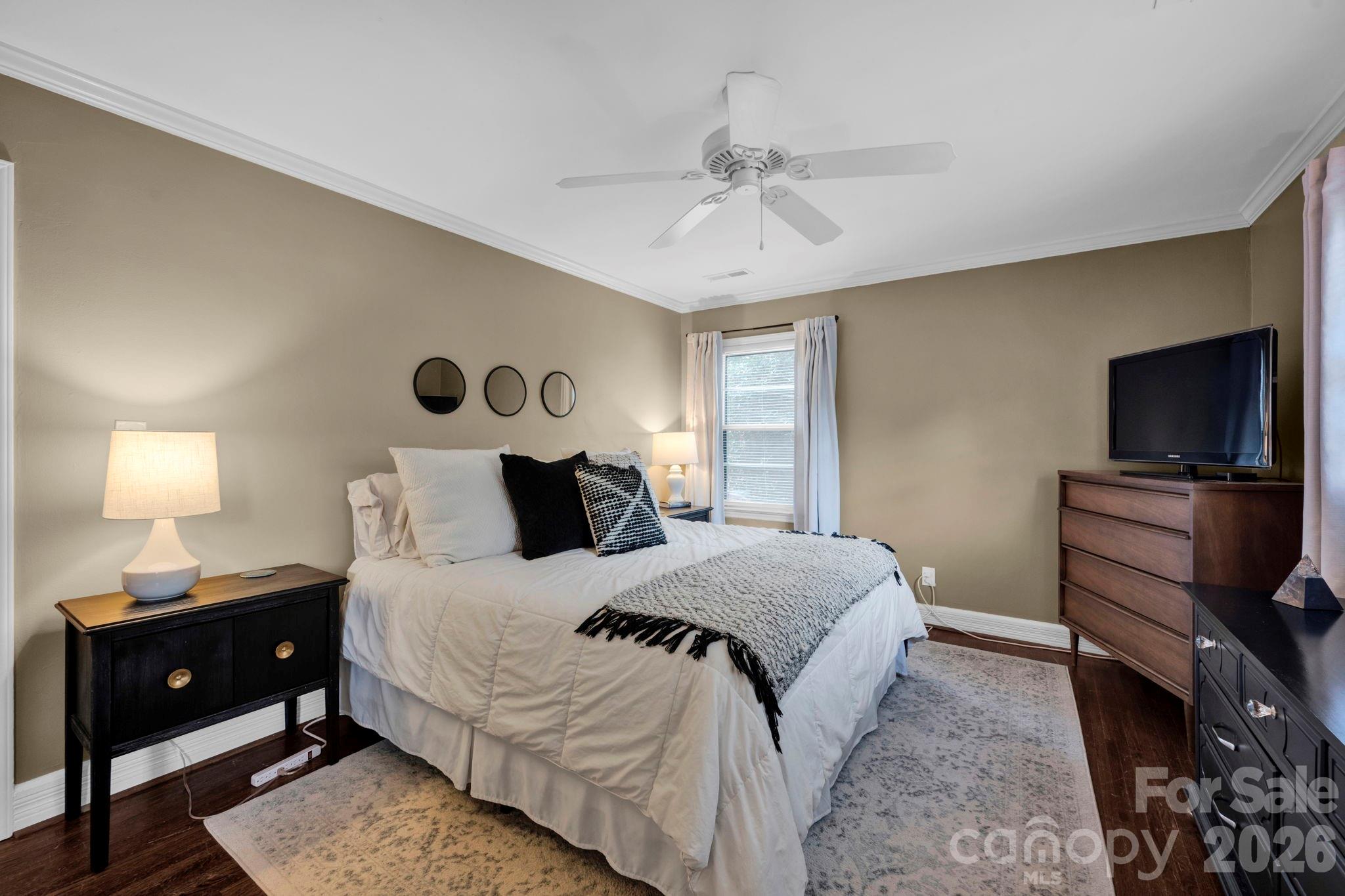 1227 Barkley Road Charlotte, NC 28209 - Photo 18 of 37 a bedroom with a bed and a flat tv screen on dresser