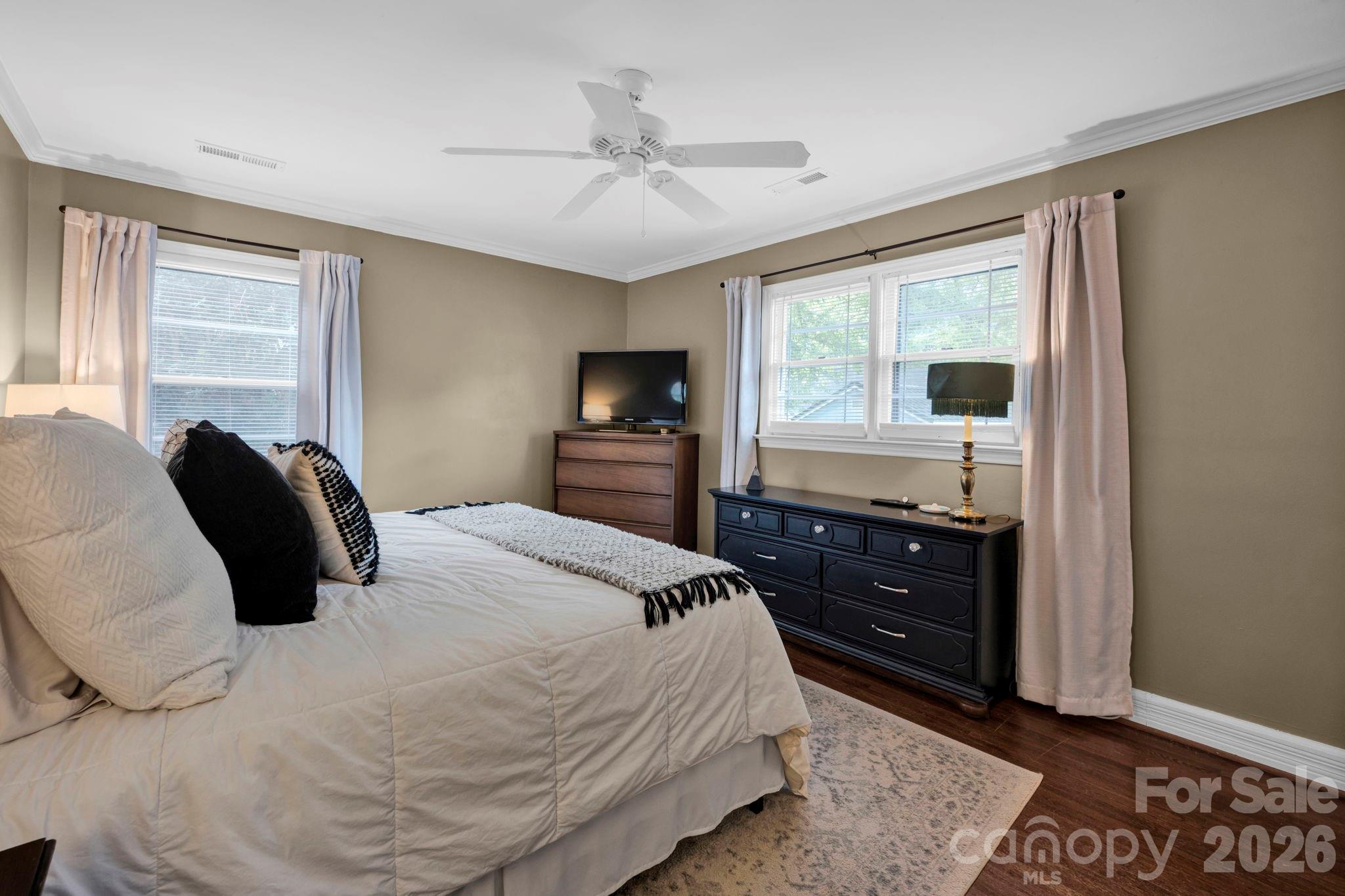 1227 Barkley Road Charlotte, NC 28209 - Photo 19 of 37 a bedroom with a bed and wooden floor